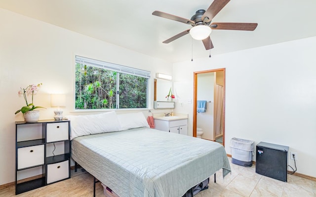 bedroom with ensuite bathroom, ceiling fan, and sink