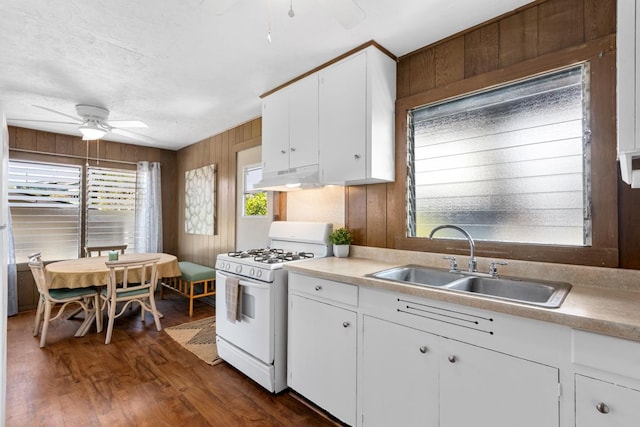 kitchen featuring under cabinet range hood, ceiling fan, a sink, and white gas stove