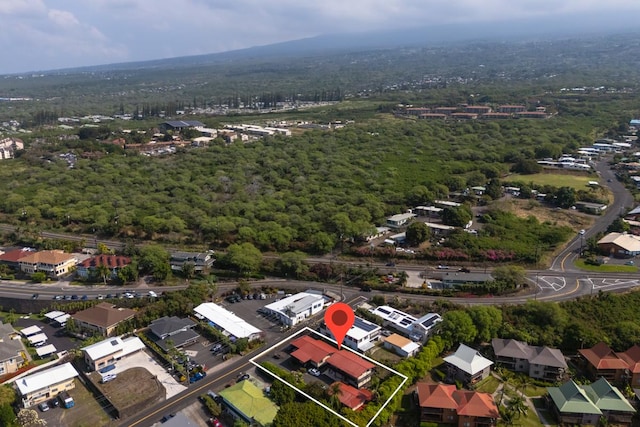 birds eye view of property with a view of trees