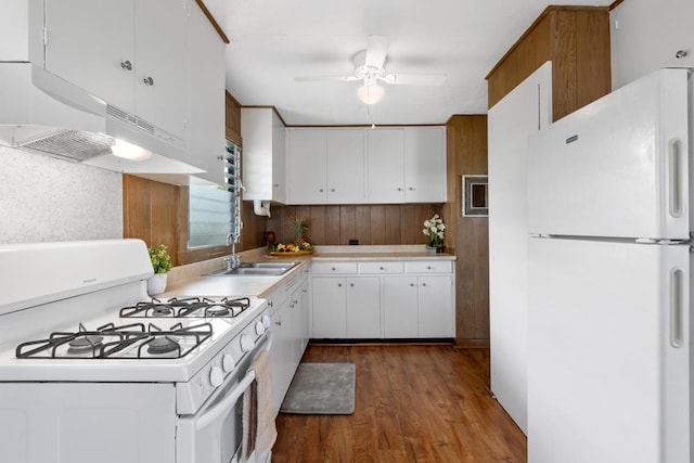 kitchen featuring white appliances, dark wood-style flooring, a sink, white cabinetry, and light countertops