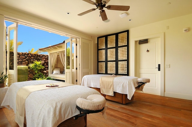 bedroom with ceiling fan and light hardwood / wood-style floors