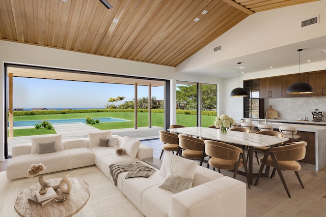 sunroom featuring a water view, wooden ceiling, and vaulted ceiling