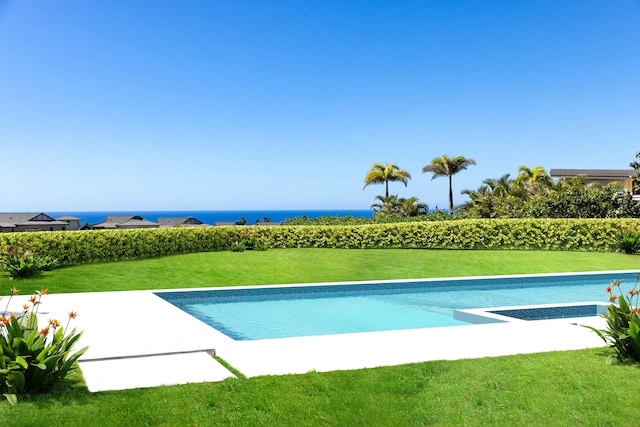 view of swimming pool featuring a yard and a water view