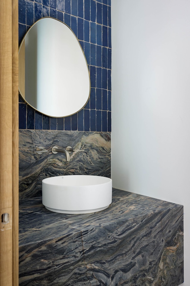 bathroom with tile walls and sink