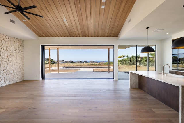 unfurnished dining area featuring sink, light hardwood / wood-style flooring, a wealth of natural light, and ceiling fan