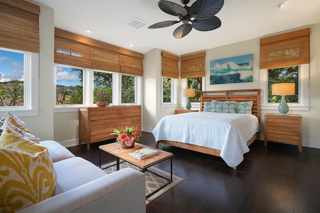 bedroom with dark hardwood / wood-style floors and ceiling fan