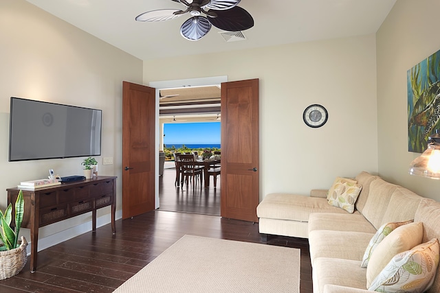 living room featuring dark hardwood / wood-style flooring and ceiling fan