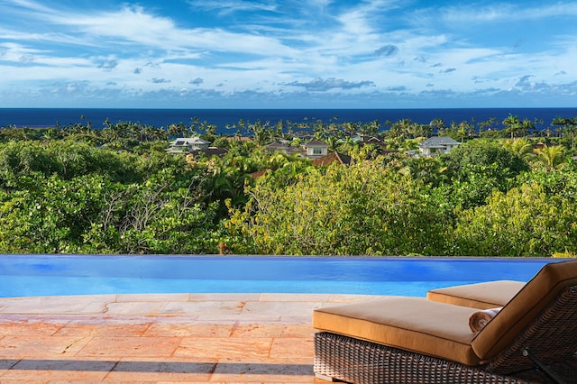 view of swimming pool with a water view