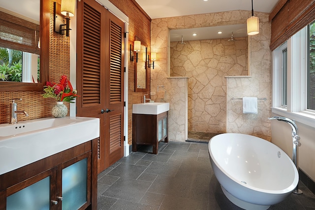 bathroom with plus walk in shower, vanity, and tile walls