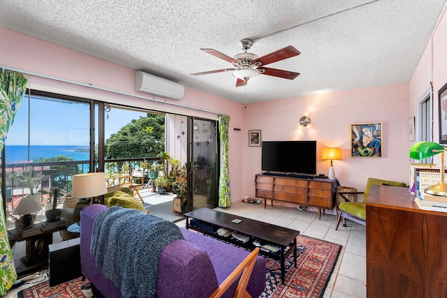 living room with ceiling fan, a wall mounted air conditioner, a textured ceiling, a water view, and light tile patterned floors