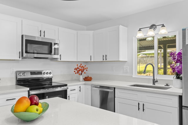 kitchen featuring sink, white cabinetry, and stainless steel appliances