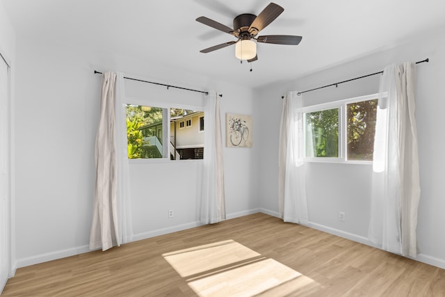 spare room featuring ceiling fan and light hardwood / wood-style floors