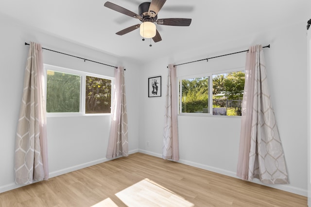 spare room featuring light hardwood / wood-style floors and ceiling fan