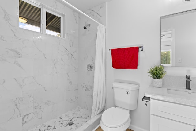 bathroom with curtained shower, vanity, and toilet