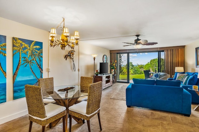 living room featuring ceiling fan with notable chandelier and floor to ceiling windows