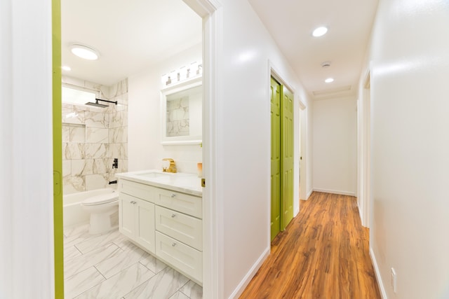 corridor featuring light hardwood / wood-style flooring and sink