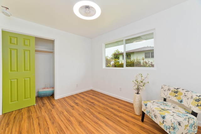 living area with hardwood / wood-style flooring