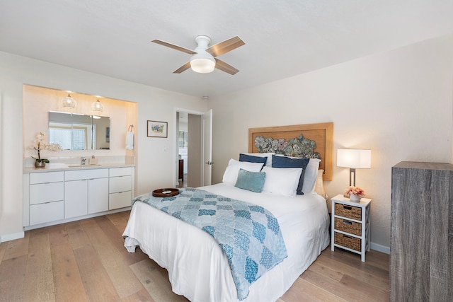 bedroom featuring ceiling fan, sink, and light hardwood / wood-style floors