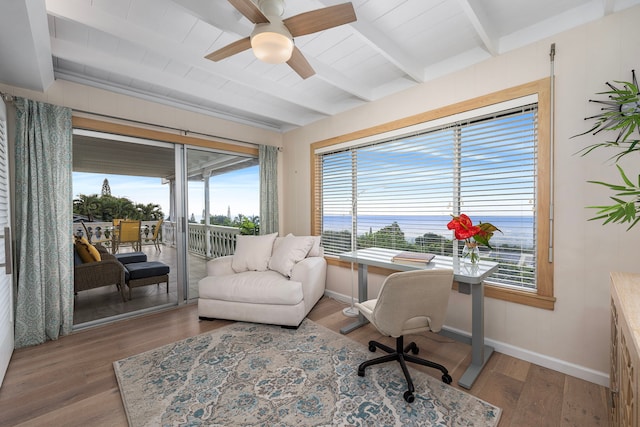 home office featuring beamed ceiling, hardwood / wood-style floors, a water view, and ceiling fan