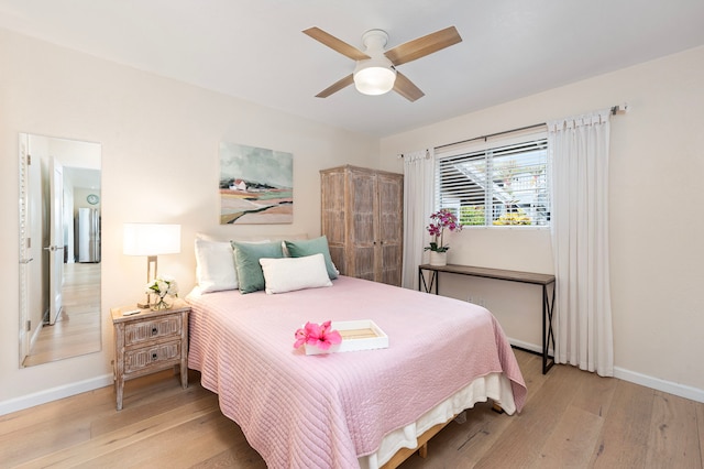 bedroom with ceiling fan and light hardwood / wood-style flooring