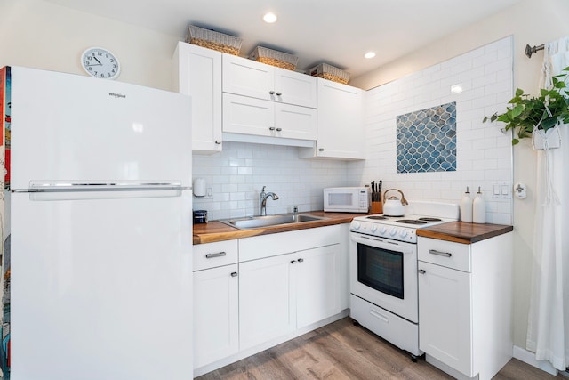 kitchen featuring wooden counters, white appliances, white cabinets, and sink