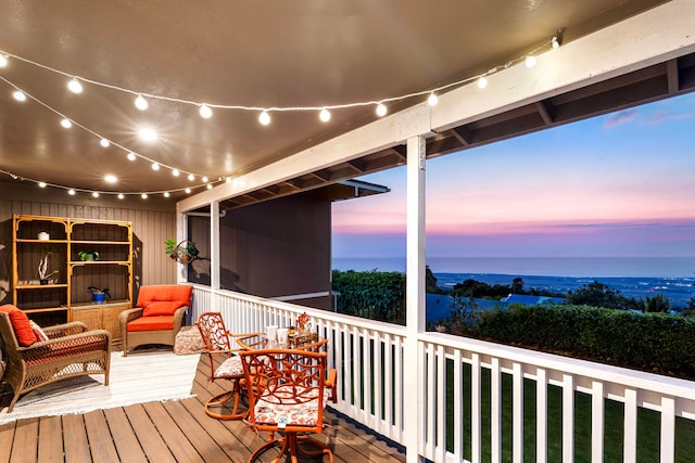 deck at dusk with outdoor lounge area