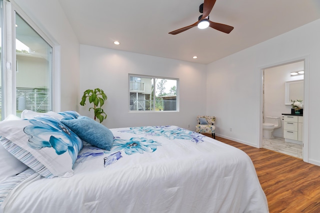 bedroom featuring connected bathroom, ceiling fan, and light wood-type flooring