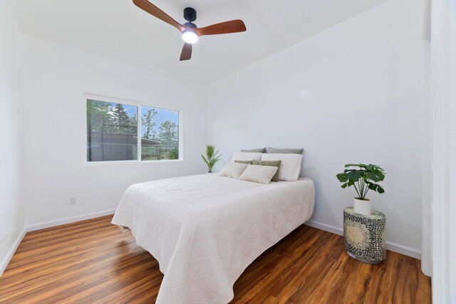 bedroom featuring ceiling fan and dark wood-type flooring