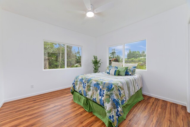 bedroom with ceiling fan and wood-type flooring