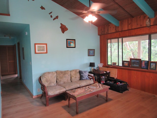 living room featuring vaulted ceiling with beams, ceiling fan, light hardwood / wood-style flooring, and wooden ceiling