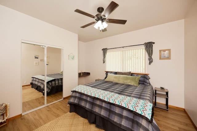 bedroom featuring hardwood / wood-style flooring, ceiling fan, and a closet