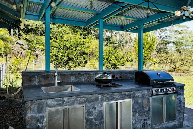 view of patio / terrace featuring an outdoor kitchen, a grill, and sink