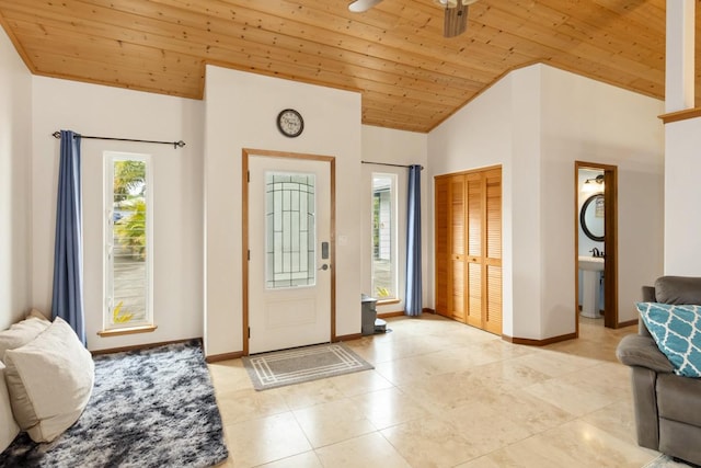 foyer entrance featuring ceiling fan, wood ceiling, and high vaulted ceiling