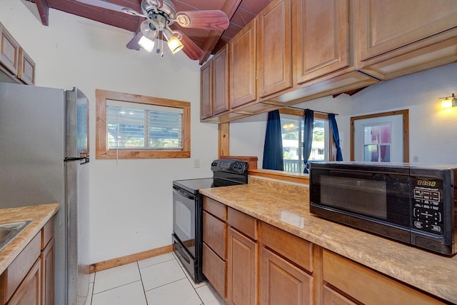 kitchen featuring electric range, ceiling fan, stainless steel fridge, and light tile patterned floors