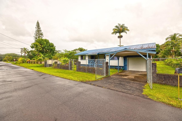 view of front of property with a carport and a front lawn