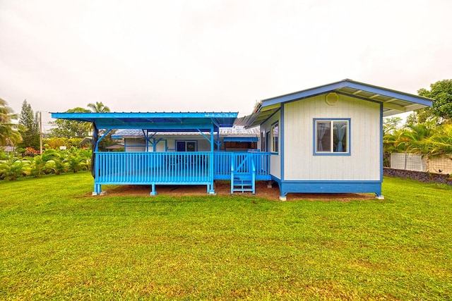 back of house featuring a deck and a yard