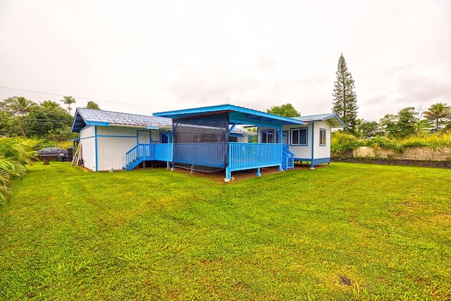 rear view of property featuring a yard