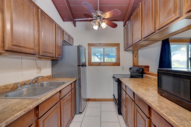 kitchen with vaulted ceiling, ceiling fan, sink, black appliances, and light tile patterned flooring