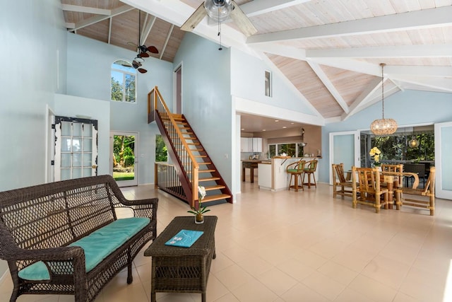 interior space featuring beamed ceiling, ceiling fan with notable chandelier, high vaulted ceiling, and wood ceiling