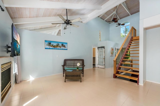 interior space with ceiling fan, beam ceiling, wood ceiling, and high vaulted ceiling