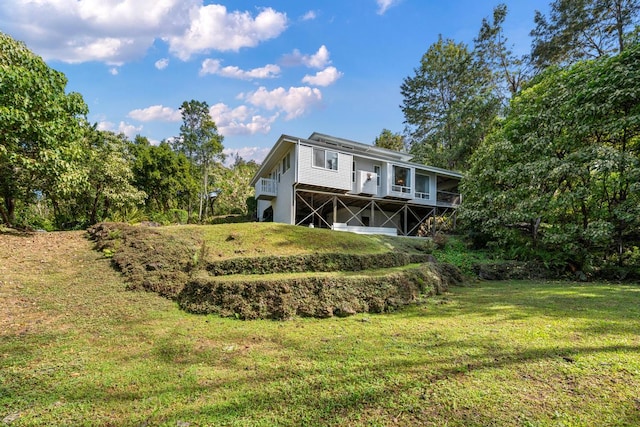 back of house with a lawn and a deck