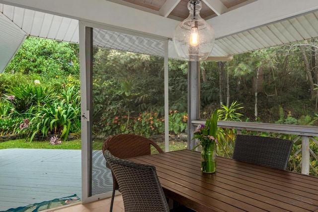 sunroom featuring beamed ceiling