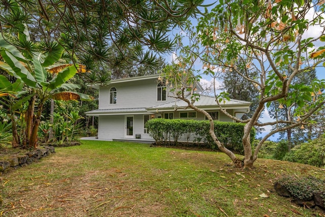 back of house with a lawn