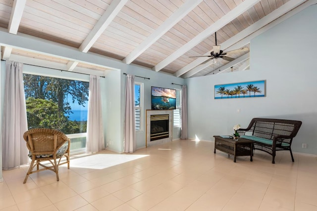 sitting room featuring vaulted ceiling with beams, light tile patterned flooring, wood ceiling, and ceiling fan