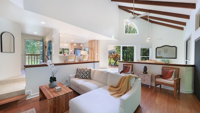 living room with beamed ceiling, dark hardwood / wood-style flooring, and high vaulted ceiling