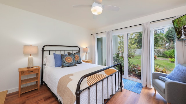 bedroom with hardwood / wood-style flooring, ceiling fan, and access to outside