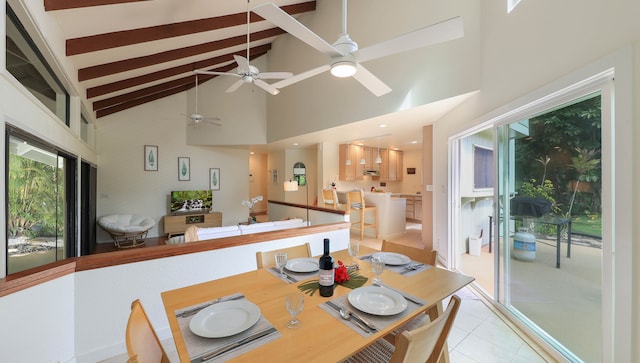 dining room with high vaulted ceiling and light tile patterned flooring