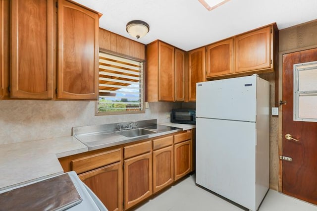 kitchen featuring white fridge and sink