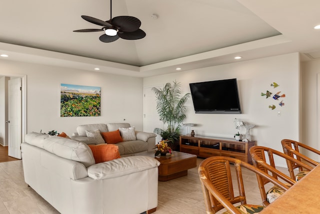 living room with high vaulted ceiling, a raised ceiling, and ceiling fan