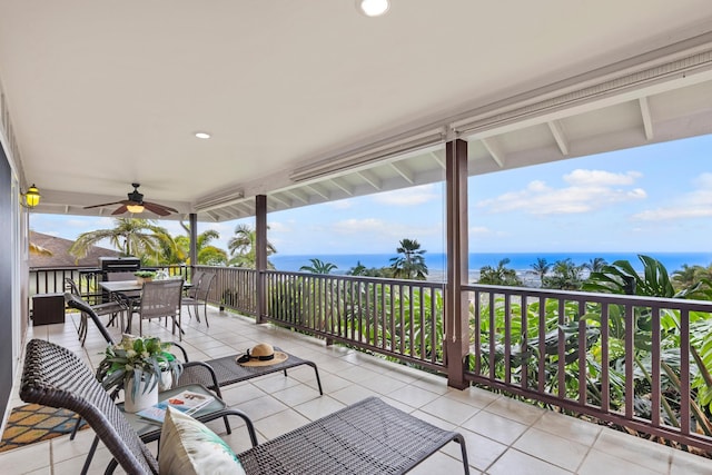 view of patio / terrace featuring ceiling fan, a water view, and a balcony